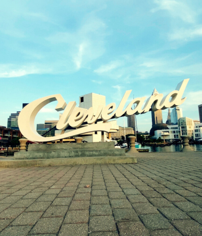 Cleveland script sign in front of downtown skyline