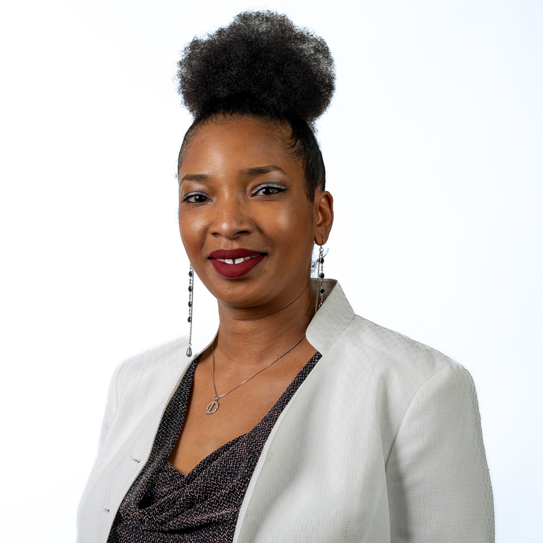 african american woman in white jacket smiling at the camera